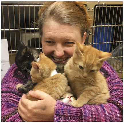 FOTAS volunteer Miranda Paton holds a “bouquet” of foster kittens.